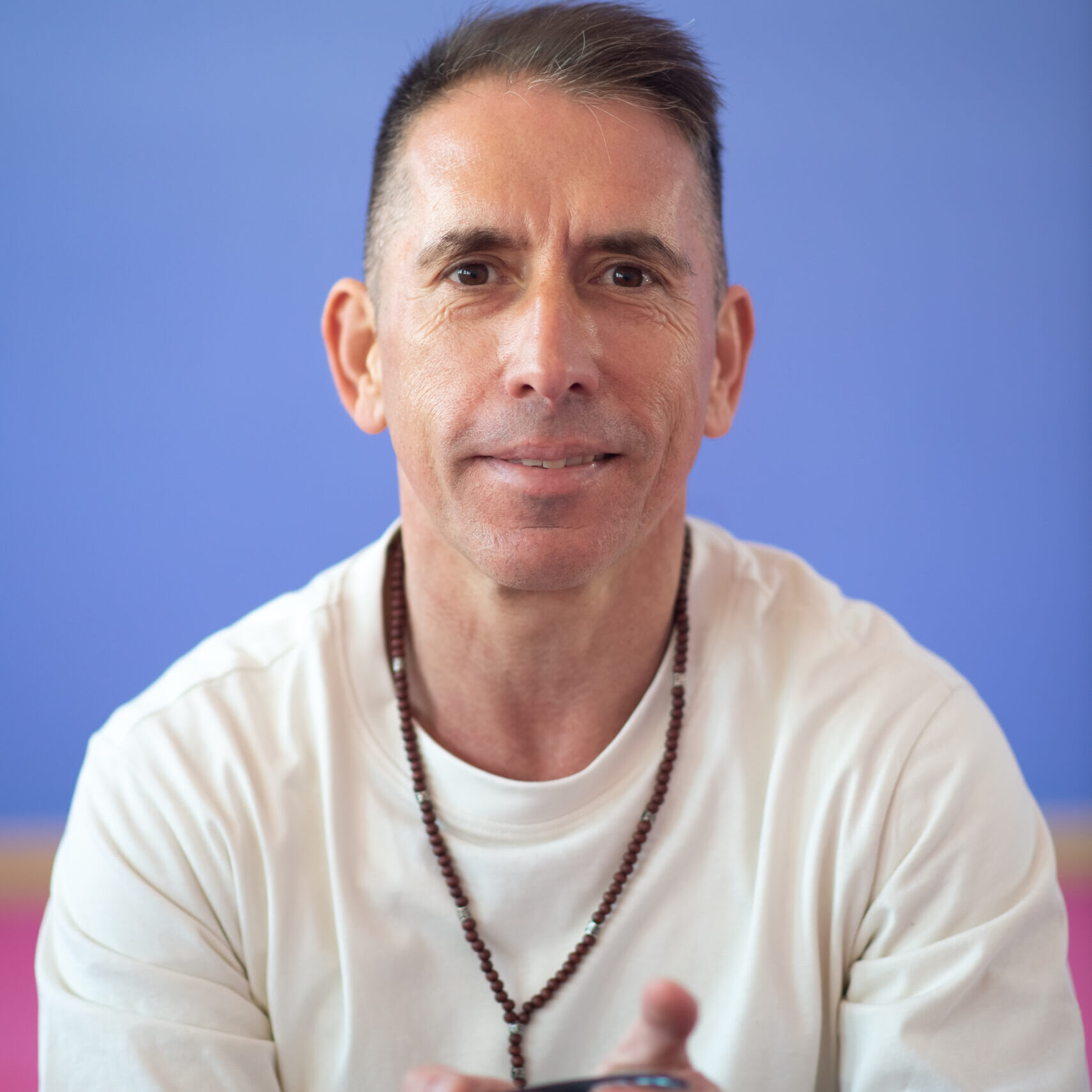 Portrait of smiling man holding bowl. Man in casual clothes looking at camera. Spirituality, health   concept